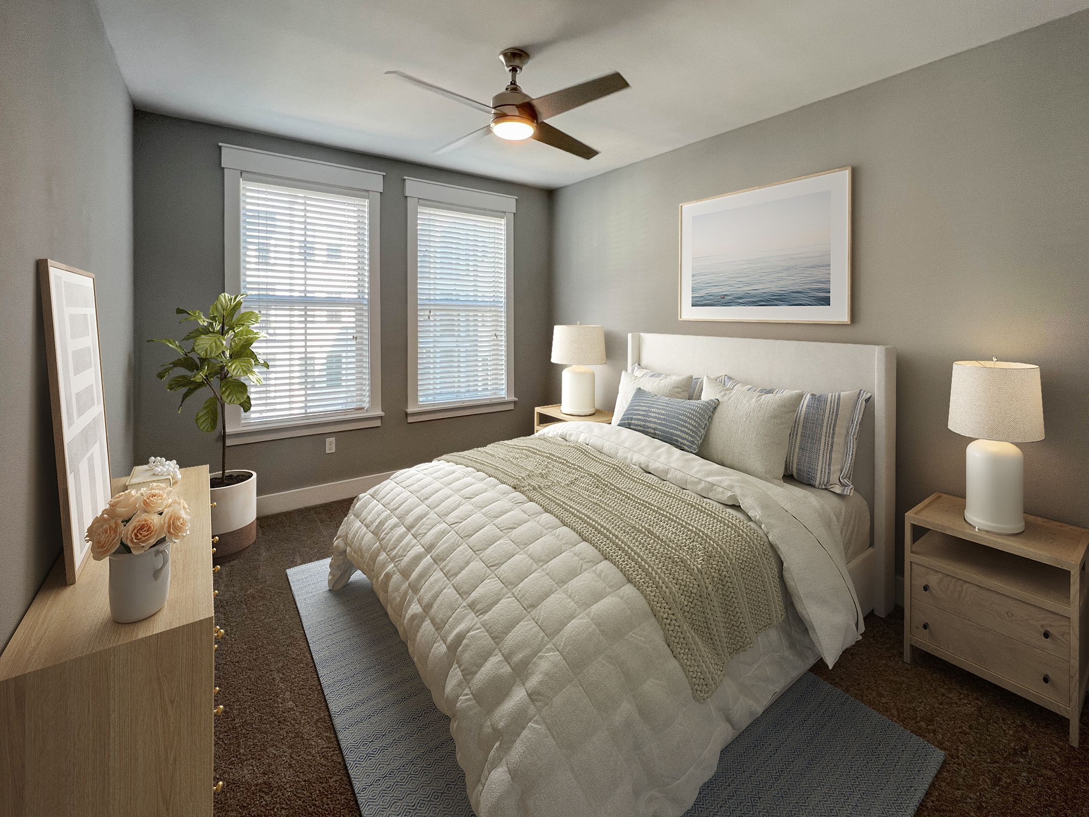 Novus Modern bedroom with a large bed, two nightstands, lamps, a plant, and a ceiling fan. Sunlight filters through two windows.